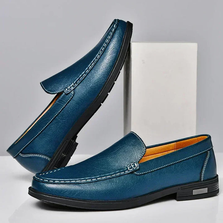 Detailed close-up of men's elegant brown leather loafers, highlighting premium texture & classic design.