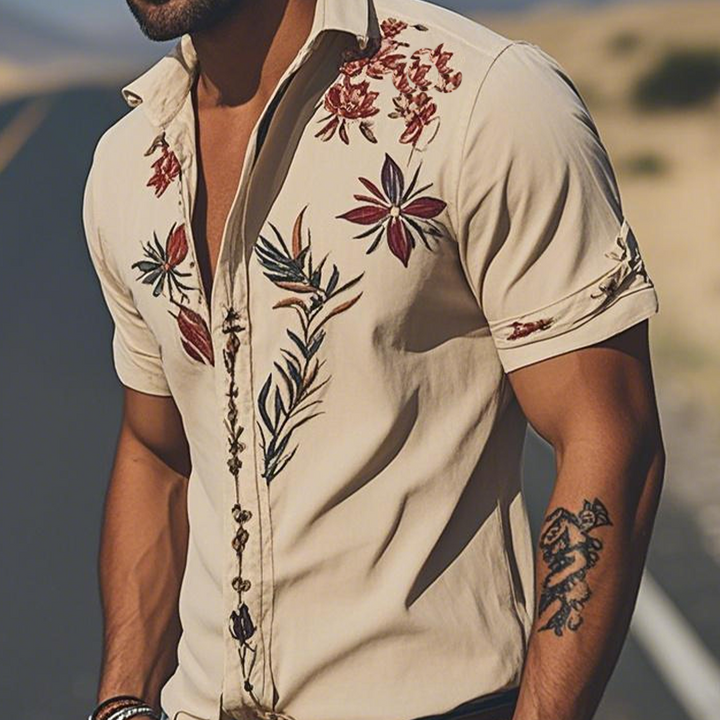 Casual men's short sleeve shirt with unique floral embroidery, offering a comfortable yet elegant western wear look.