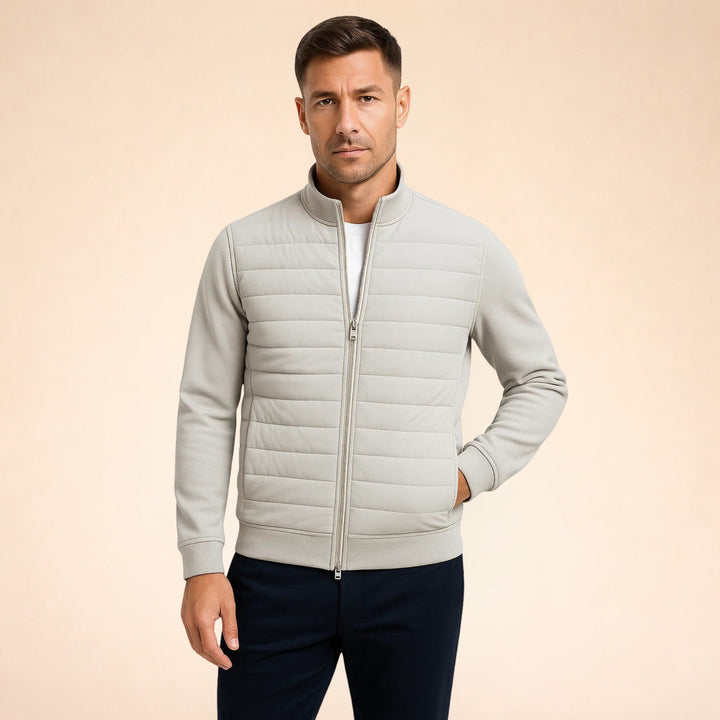 Fashionable men's casual quilted jacket. Features stretch knit sleeves for comfort & mobility. Ideal everyday wear.