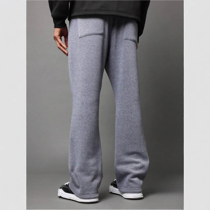 Fashionable men's flared sweatpants in light purple. Stylish comfort, perfect for modern loungewear & relaxed everyday wear.