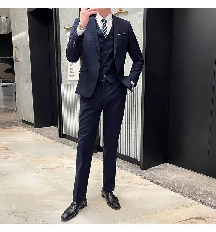 Formal three-piece men's suit, notch lapel jacket, vest, trousers, perfect for weddings.
