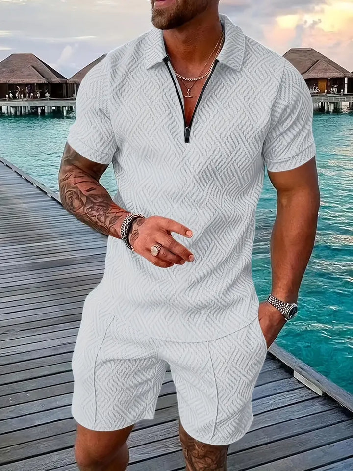 Full view of a man wearing a trendy geometric summer polo and shorts set for a casual day.