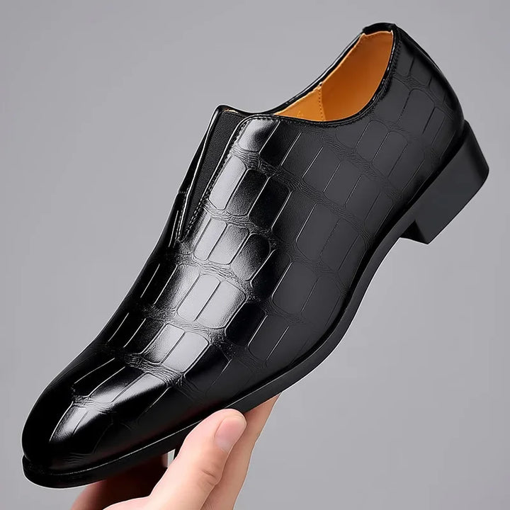 Premium men's brogues with a distinctive glossy crocodile texture and slip-on design.