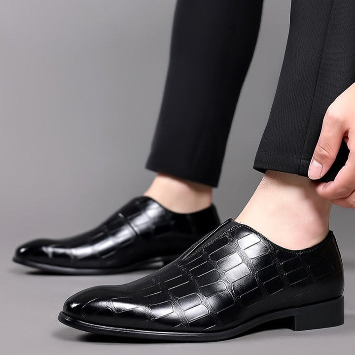 Elegant men's glossy finish slip-on brogue shoes, showcasing a sophisticated crocodile pattern.