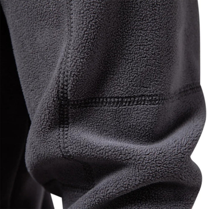 Essential men's half-zip pullover sweater with long sleeves, providing comfort and style for casual outfits.
