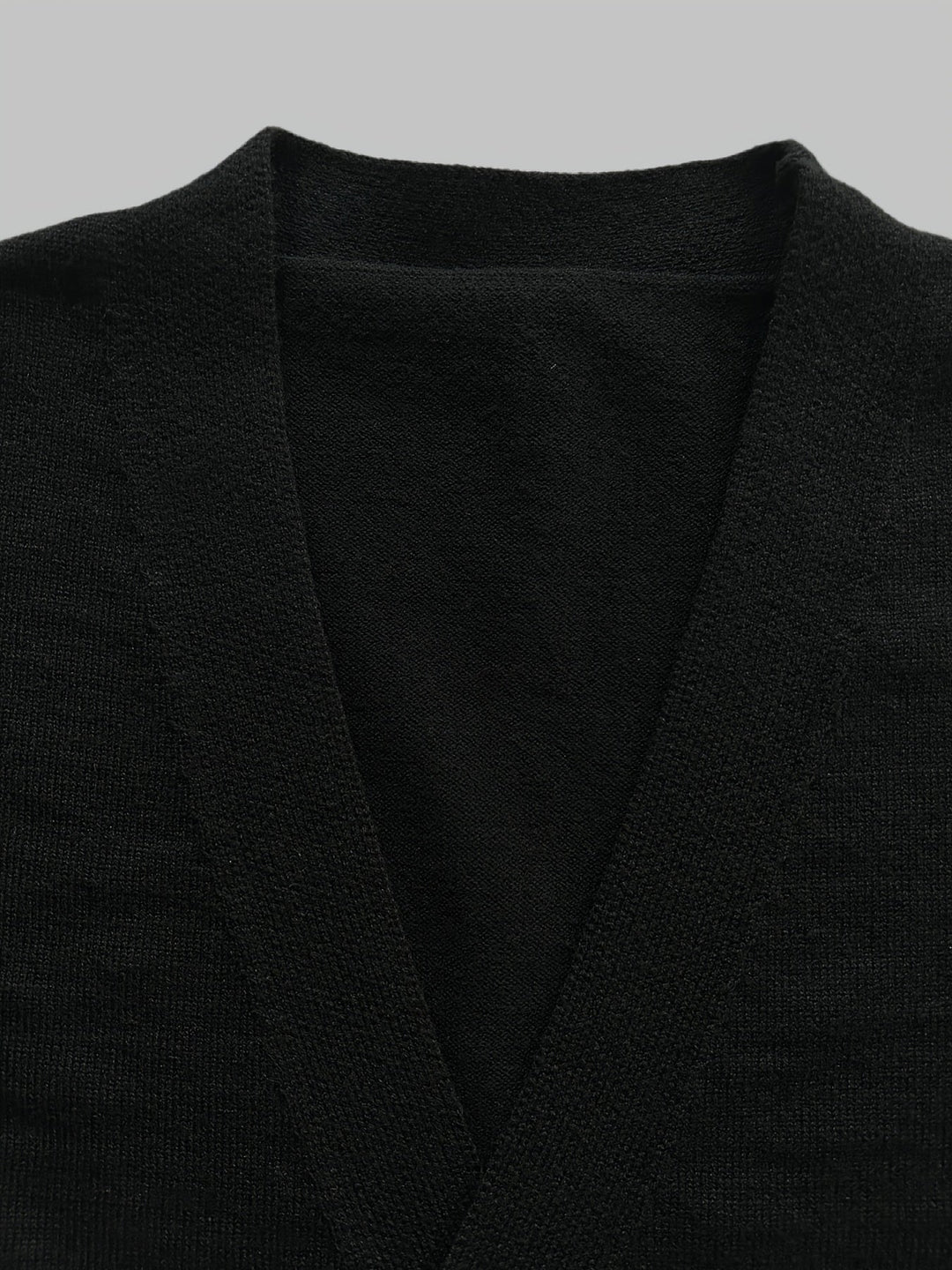 Close-up: Men's handcrafted knit button cardigan texture, showcasing jacquard pattern & quality.