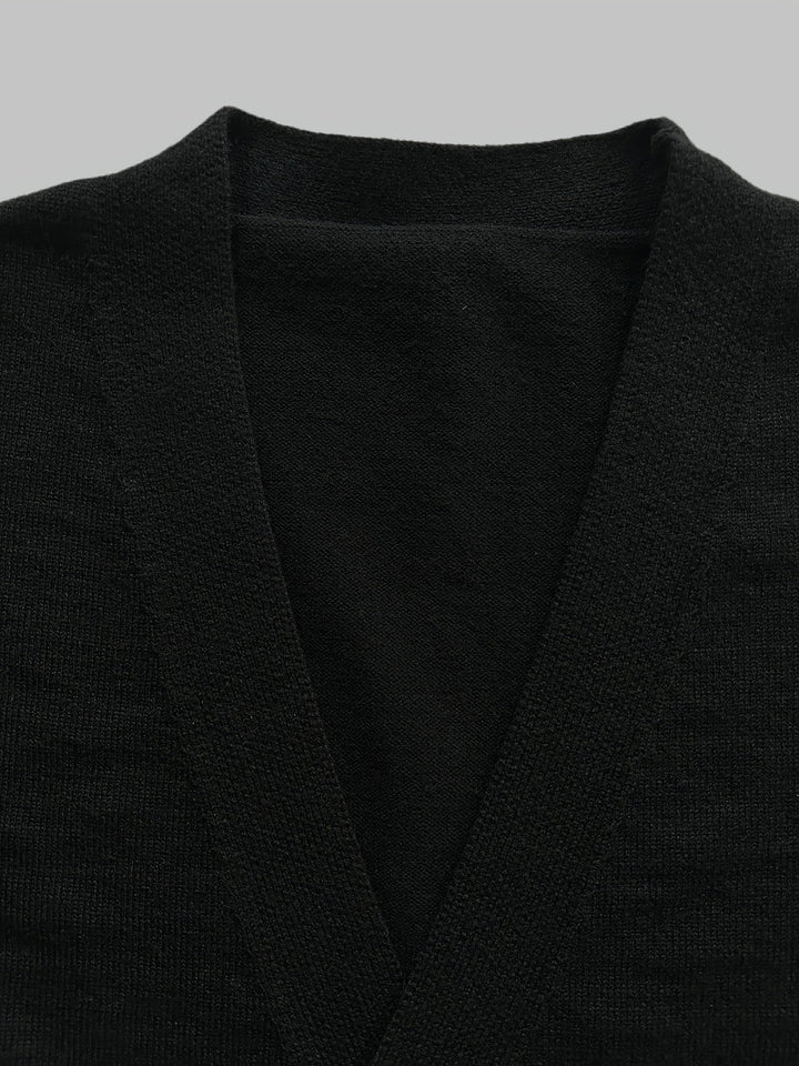 Close-up: Men's handcrafted knit button cardigan texture, showcasing jacquard pattern & quality.