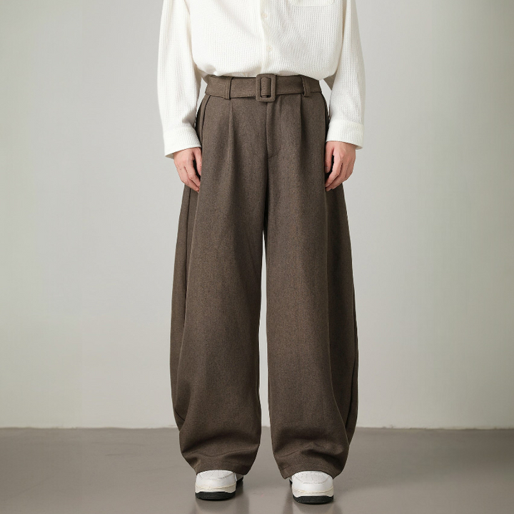 Relaxed fit men's wide leg trousers, high-waisted design, pleated details & an adjustable belt for modern fashion.
