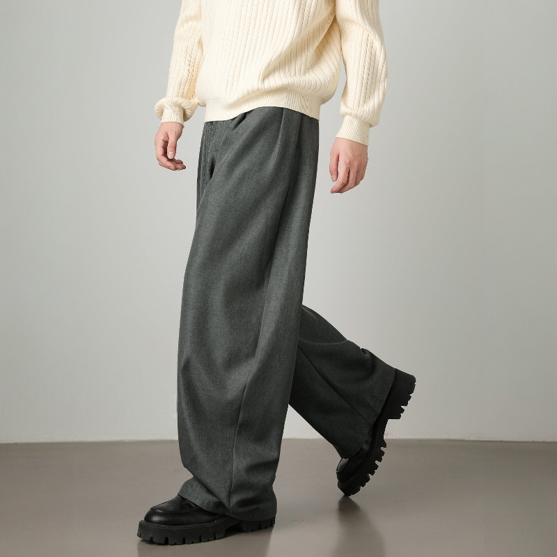 Modern men's fashion: high-waisted wide leg trousers, pleated details & an adjustable belt for a contemporary look.