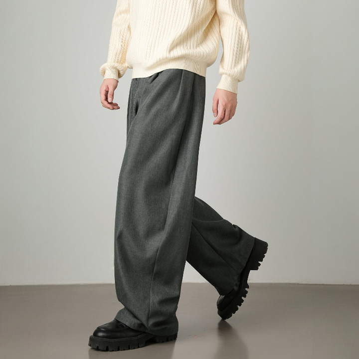 Modern men's fashion: high-waisted wide leg trousers, pleated details & an adjustable belt for a contemporary look.