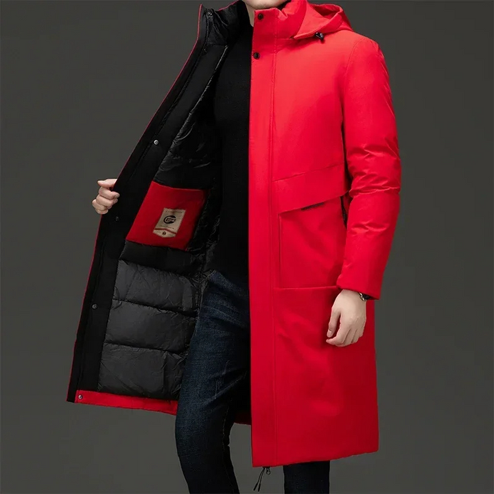Man wearing a stylish black hooded long coat. Warm winter jacket for men's fashion and cold weather.