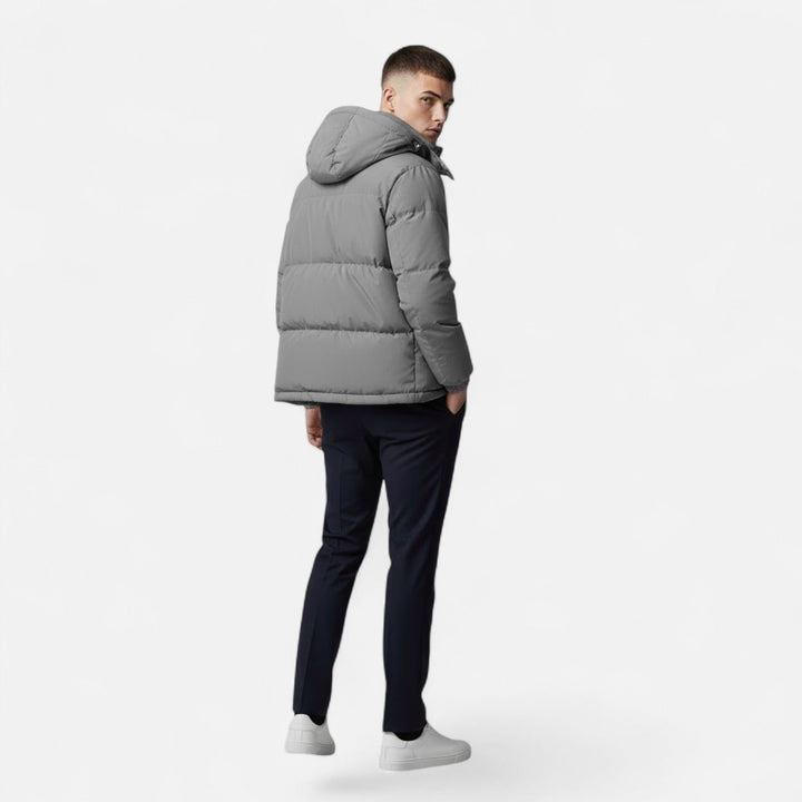 Side profile of a men's stylish hooded padded jacket, offering warmth and modern winter outerwear.