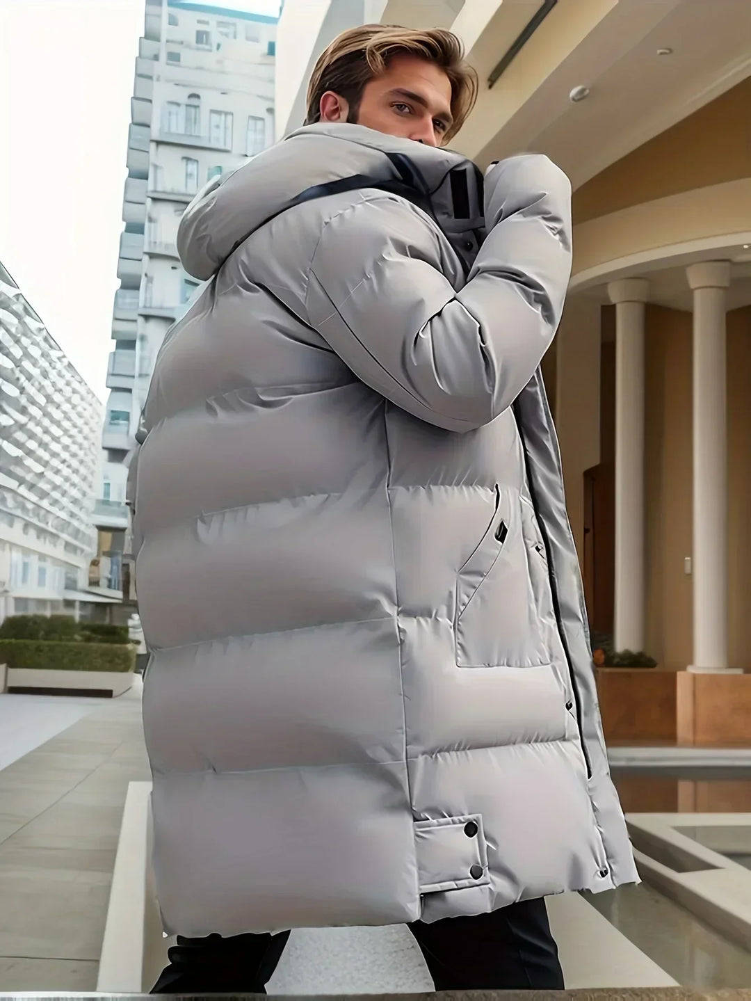 Front view of a warm men's winter jacket with a quilted design and functional hood.