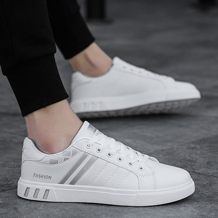 Modern mens low-top lace-up sneakers with a round toe, designed for comfortable athletic and casual everyday use.
