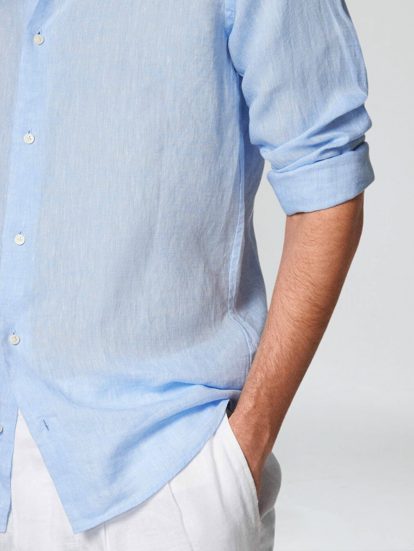 Light blue men's breathable button-down shirt, long-sleeve, offering comfort for summer and warm weather.