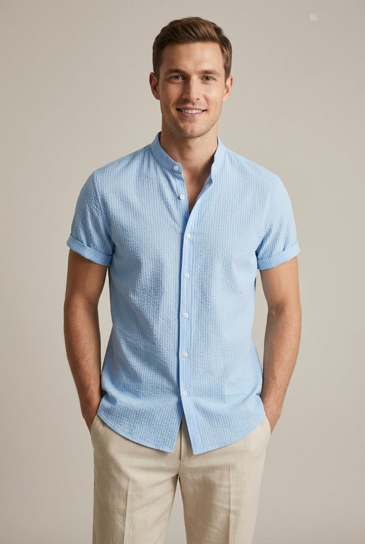 Men's light blue seersucker short sleeve shirt with band collar for stylish summer casual wear.