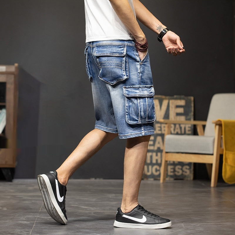 Comfortable men's knee-length utility cargo shorts in a light wash with practical pockets for casual summer style.