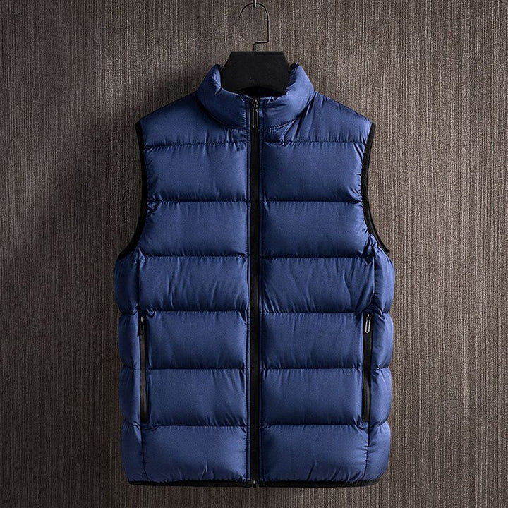 Outdoor men's sleeveless quilted puffer vest, providing lightweight warmth & comfort for active winter layering.