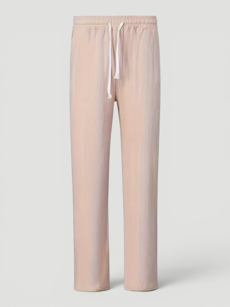Man relaxing indoors wearing versatile lightweight straight leg men's comfort pants.