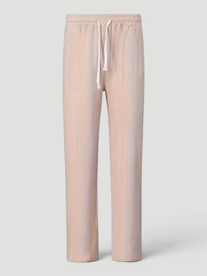 Man relaxing indoors wearing versatile lightweight straight leg men's comfort pants.