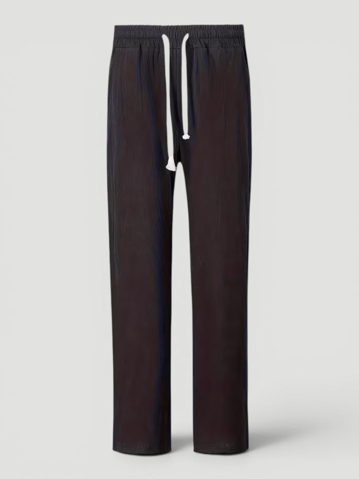 Folded men's lightweight straight leg pants, ideal for versatile everyday wear & travel comfort.