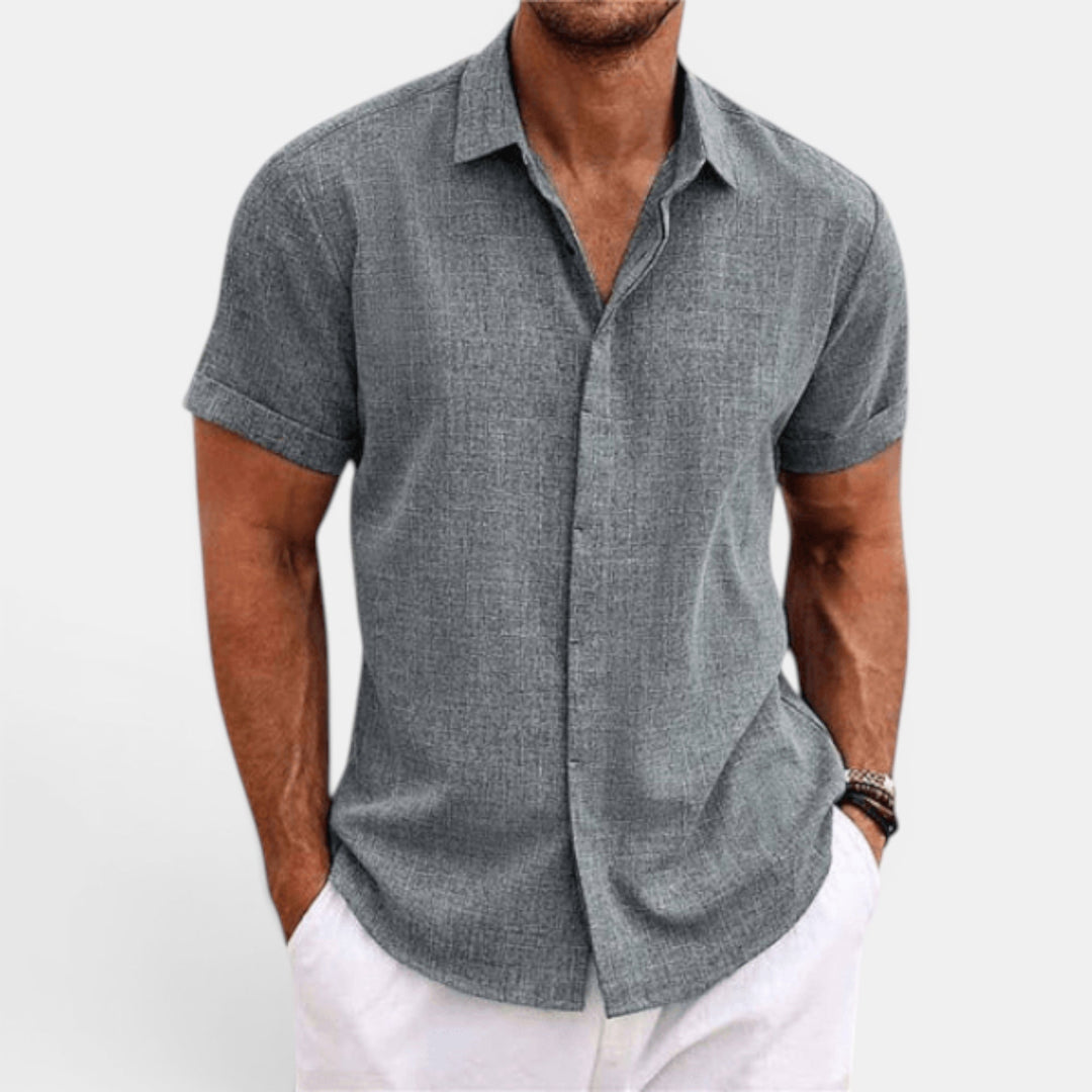 Man in lightweight short sleeve button-up summer shirt. Perfect casual top for relaxed men's fashion.