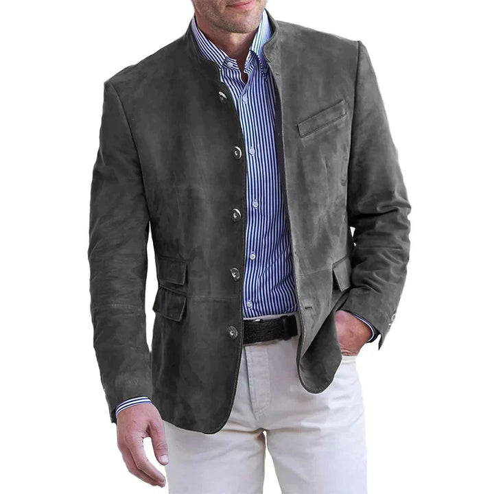 A man wearing a navy lightweight tailored fit blazer with a distinctive mandarin collar.