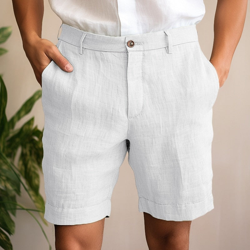 Model wearing men's lightweight beige chino shorts, showcasing relaxed fit & stylish look for summer activities.