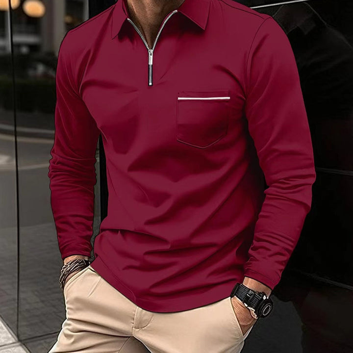 A man's hand adjusting the collar of a warm, stylish long sleeve polo shirt for smart casual fashion.