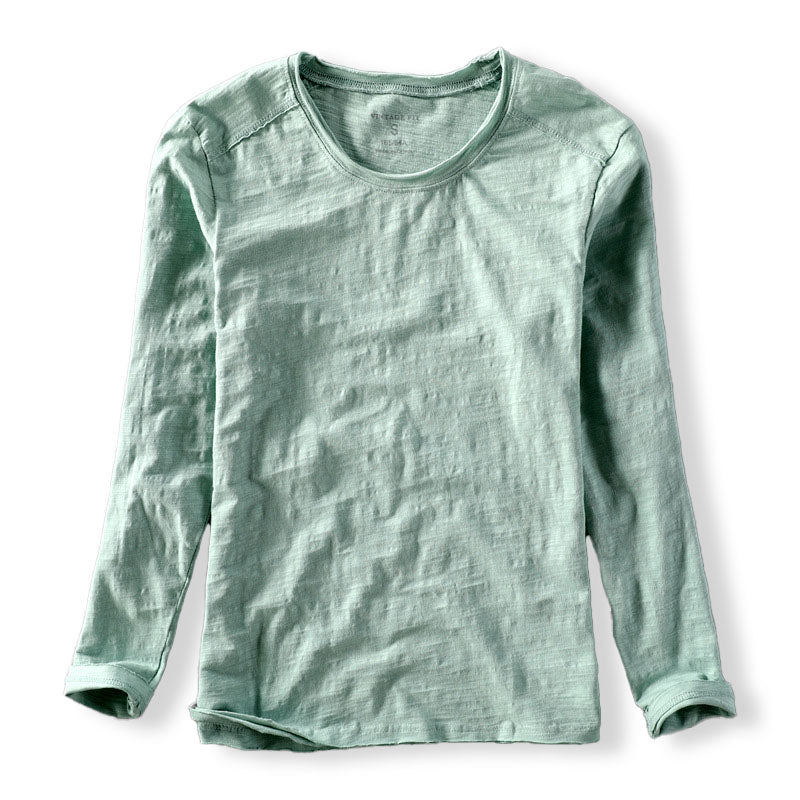 Close-up of a men's casual long sleeve shirt showing its unique textured fabric and classic crew neck design.