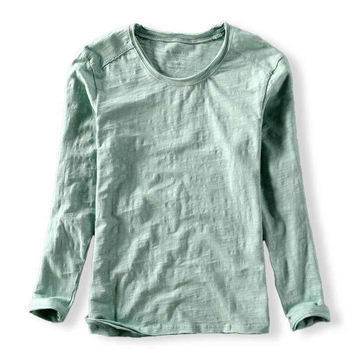 Close-up of a men's casual long sleeve shirt showing its unique textured fabric and classic crew neck design.