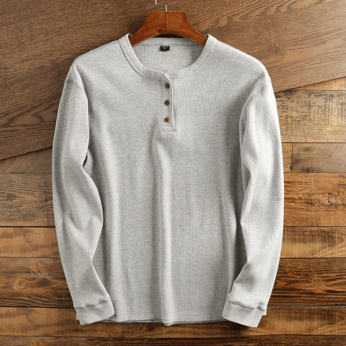 Men's long sleeve waffle knit henley shirt in a rich navy blue color.