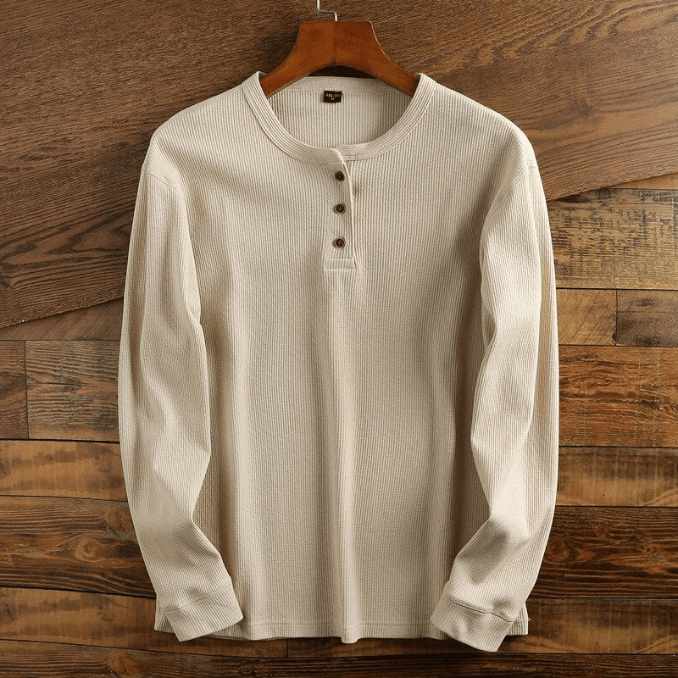 Front view of a men's waffle knit henley shirt, showcasing its relaxed fit.