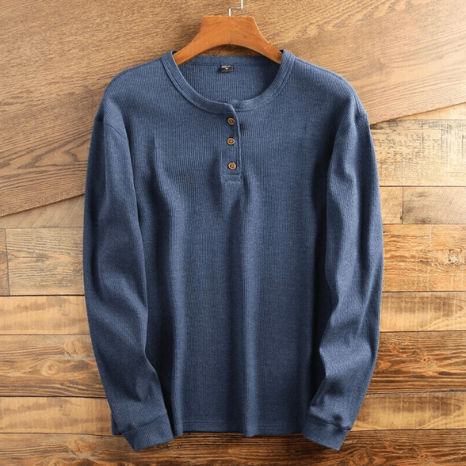 Detailed shot of the buttons and collar on a men's long sleeve textured henley.