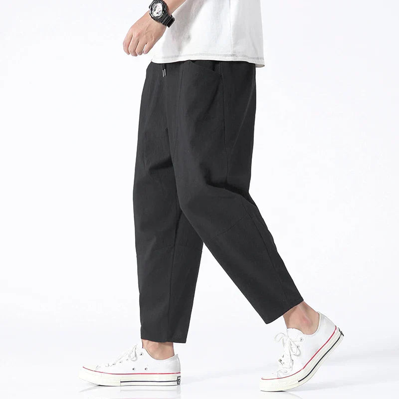Relaxed men's ankle-length cropped drawstring chinos, loose fit for comfortable summer fashion.