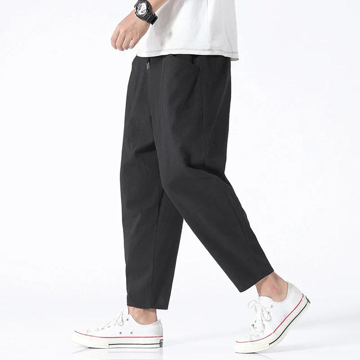 Relaxed men's ankle-length cropped drawstring chinos, loose fit for comfortable summer fashion.
