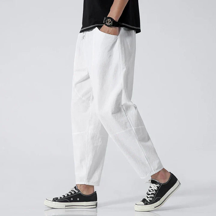 Versatile men's loose fit cropped chinos with drawstring waist. Ankle-length for relaxed summer style.