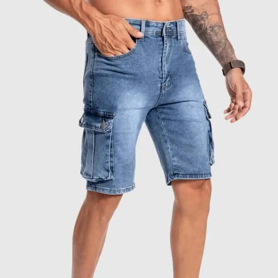 Close-up of men's denim cargo shorts, showing multiple functional utility pockets. Casual summer style.