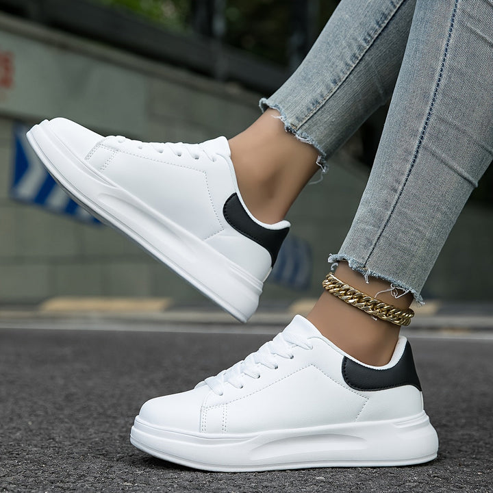 Versatile classic white sneakers for men, offering a clean, minimalist look for any casual outfit.