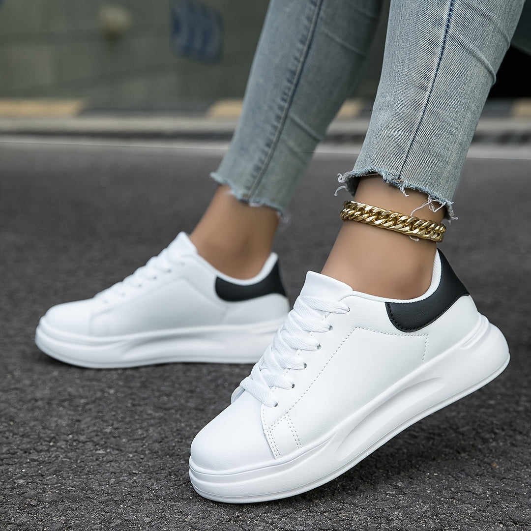 Modern men's white minimalist sneakers, embodying clean design and essential everyday street style.