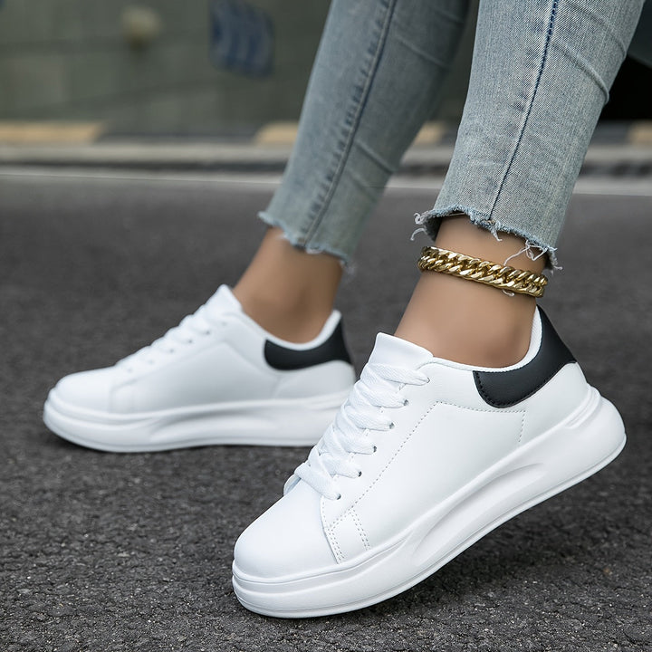 Modern men's white minimalist sneakers, embodying clean design and essential everyday street style.