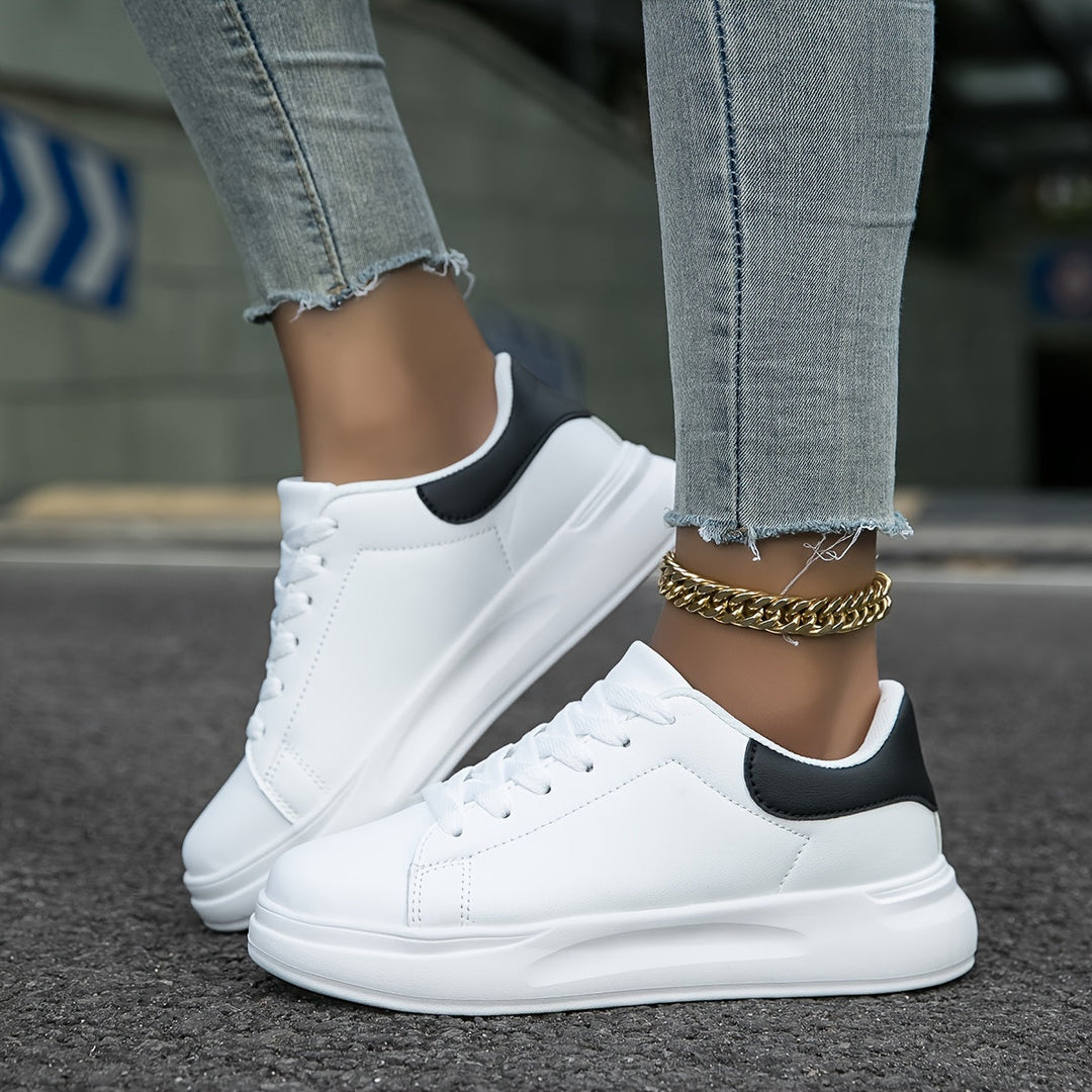 Essential men's fashion: crisp white sneakers with a minimalist design for elevated everyday wear.