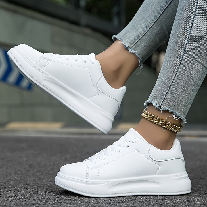 Classic white and black men's sneakers, minimalist footwear for versatile street style.