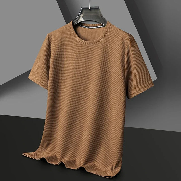 Close-up of the textured waffle knit fabric on a men's short sleeve tee