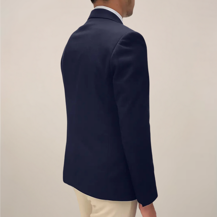 Close-up of men's tailored fit navy blue spring blazer jacket lapel detail.