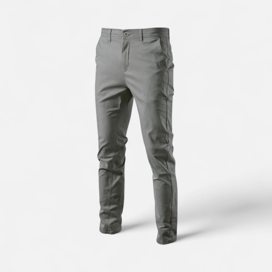 Stack of men's smart casual chinos in various colors, versatile trousers for any wardrobe.