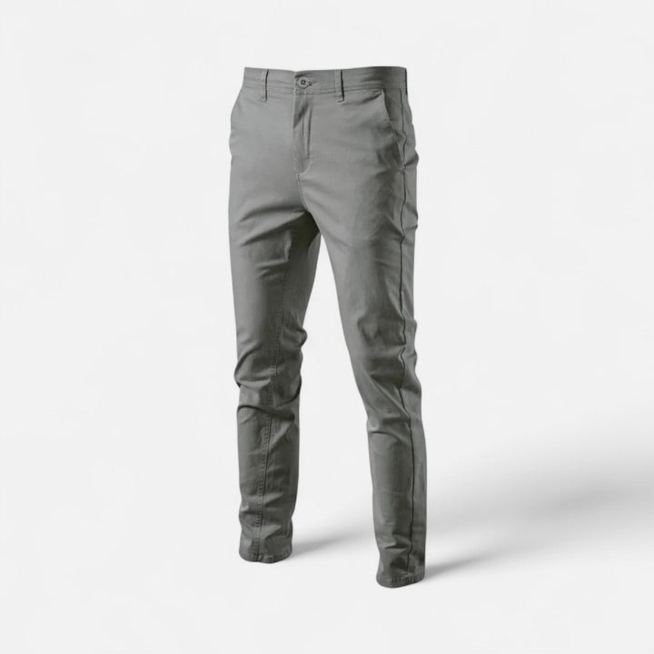 Stack of men's smart casual chinos in various colors, versatile trousers for any wardrobe.