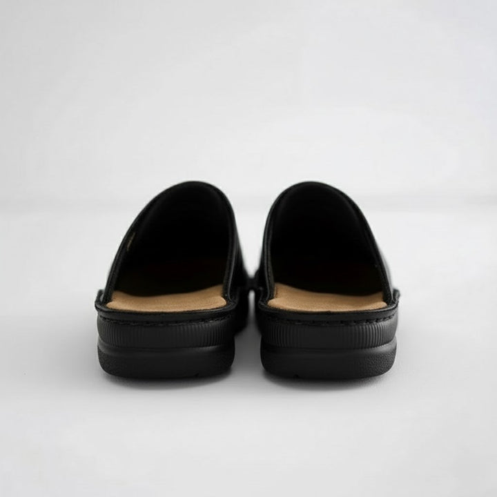 Orthopaedic sole detail on men's leather slip-on clogs, showing advanced arch support technology.