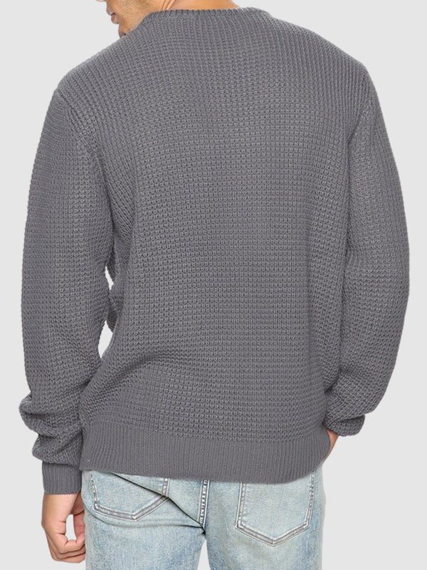 Man modeling a stylish oversized crew neck sweater, showcasing relaxed fit and long sleeves.