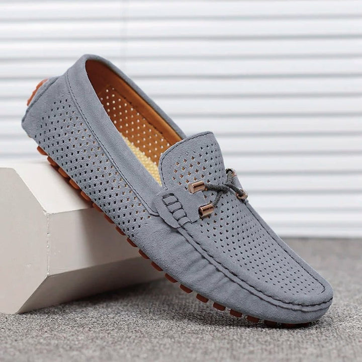 Stylish men's perforated slip-on loafers, a classic choice for modern casual fashion.